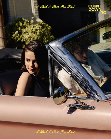 Selena Gomez and Benny Blanco sit in a convertible; Selena looks over her shoulder